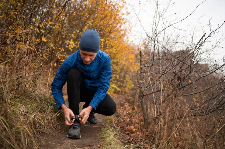man-tying-shoestrings-before-jogging-outdoors-in-fall
