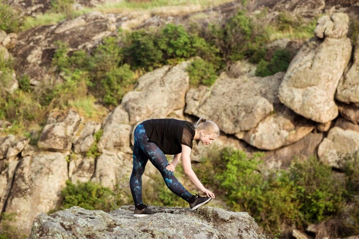 woman-stretching-on-rocks-outdoor-fitness